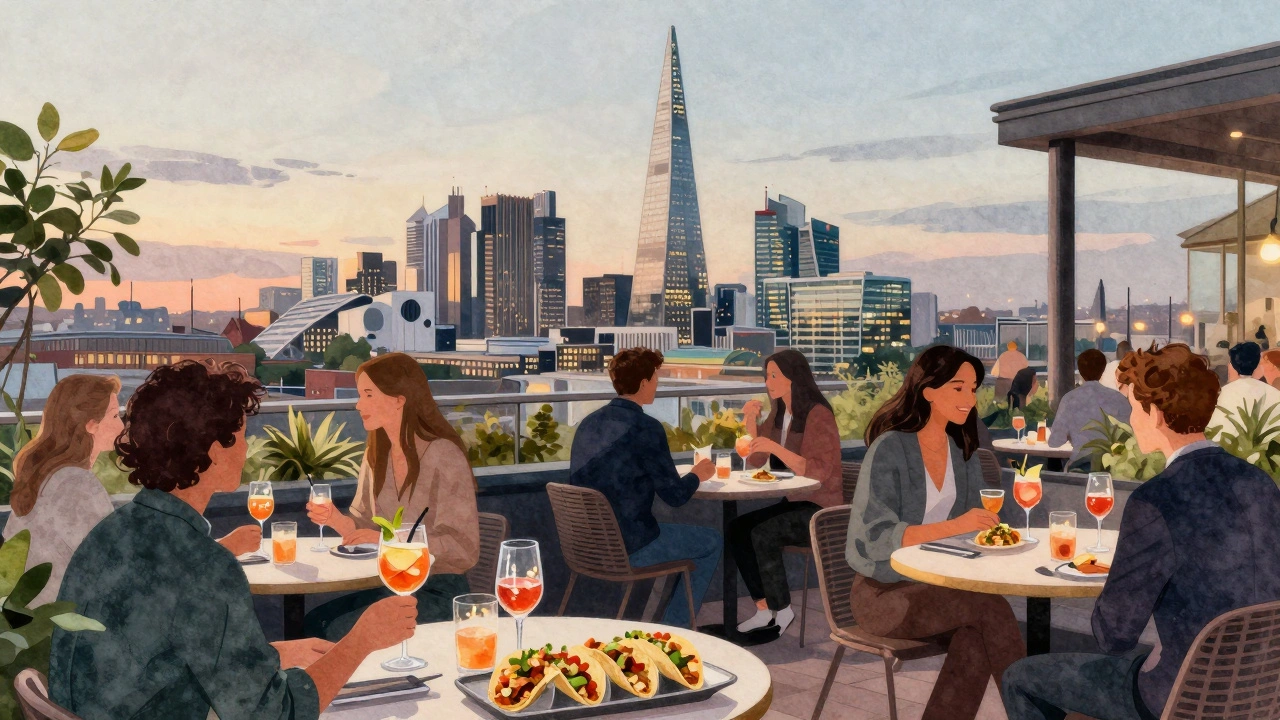 Crowd at Sky Garden rooftop sipping drinks and eating snacks with panoramic London views.
